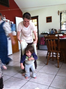 Melissa Troyer teaching Isaac how to walk 