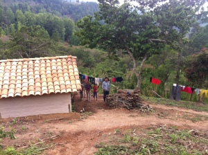 Reynaldo and some of his children in front of their house.