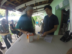 Elderly lady receiving her meds from doctor Jassyr