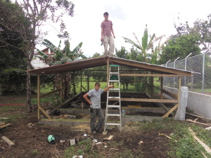 Enos and Fernando helping to build the chicken house 