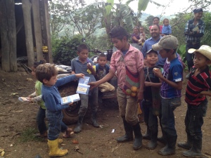 Isaac passing literature to childrens in the Chimizal village